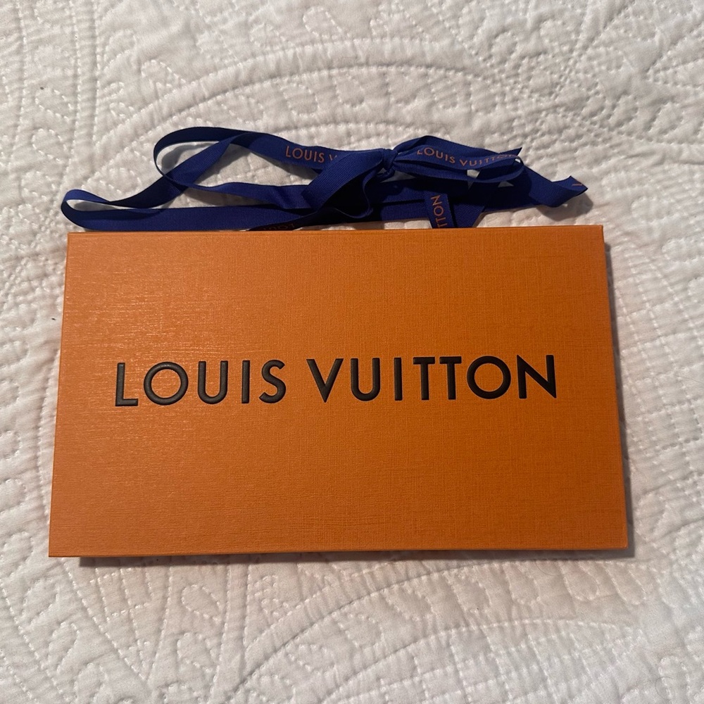 Louis Vuitton gift card box and branded ribbon.
